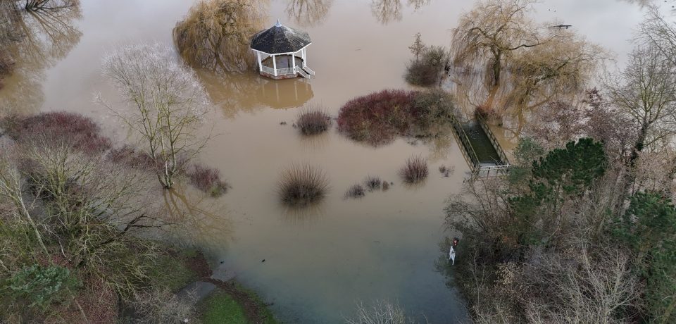 an aerial view of flood and flooded area with pavilion surrounded by water