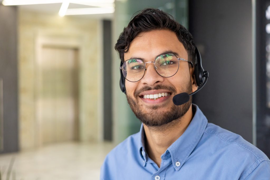 Friendly customer service representative with headset ready to assist customers